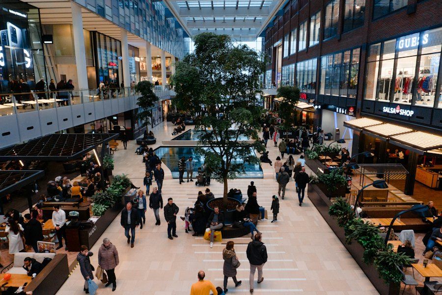 Shoppers walking through a busy shopping precinct