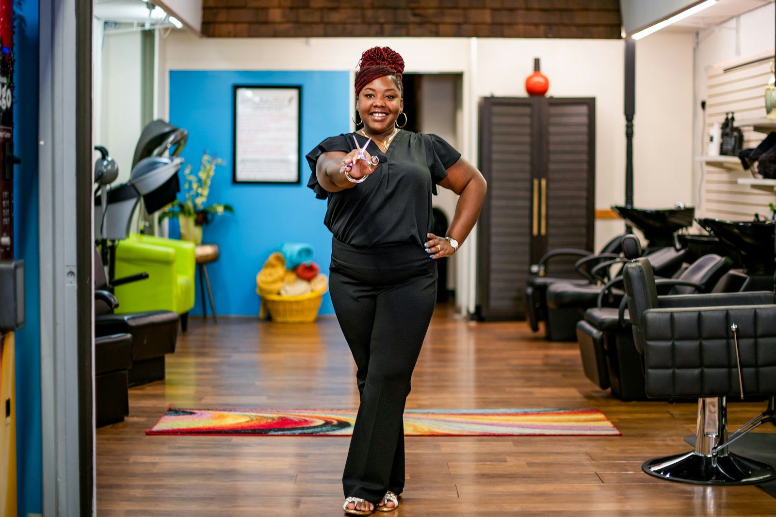 A salon owner smiling in her salon